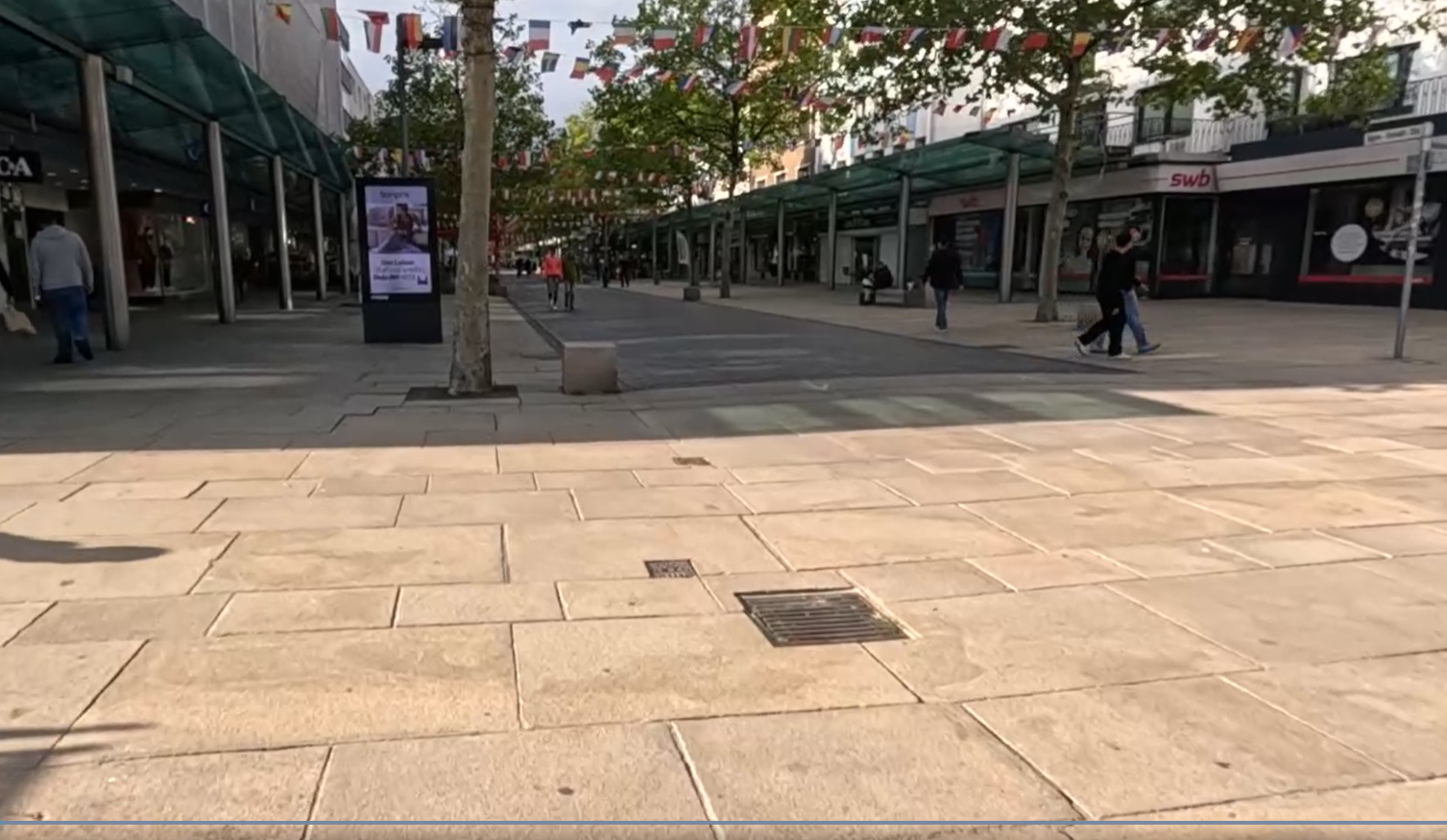 Blick die Bürger entlang mit Werbedisplay und wenig Publikum